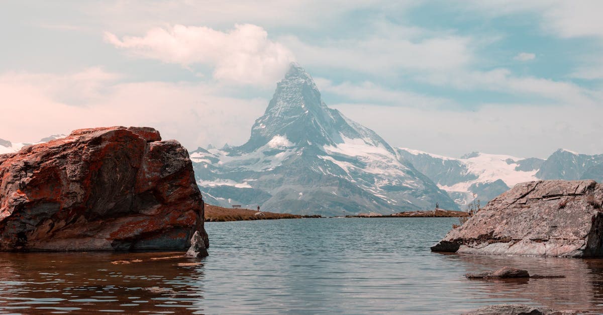 Tranquil view of the iconic Matterhorn peak reflecting on a mountain lake in Zermatt, Switzerland.