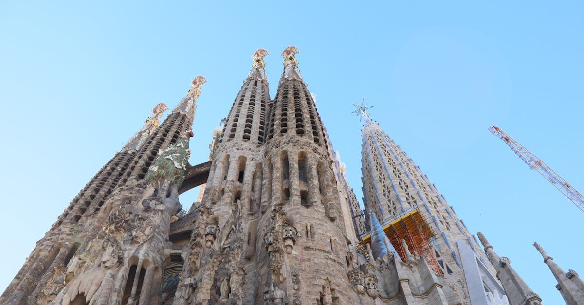 Stunning view of the Sagrada Familia's intricate facade against a clear blue sky in Barcelona.