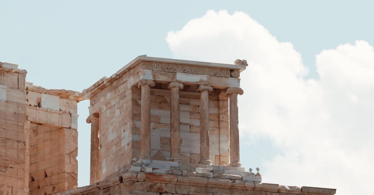 Close-up of ancient temple ruins in the Acropolis of Athens under a clear sky.