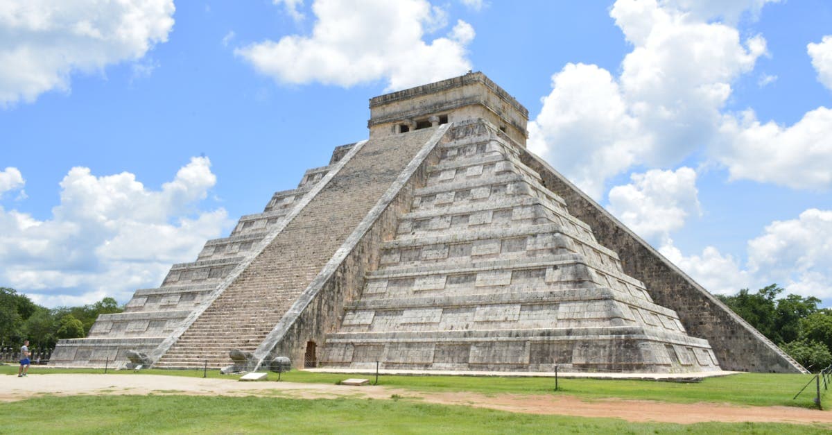 Explore the iconic Pyramid of Chichén Itzá, Yucatán, an architectural marvel under a vibrant blue sky.