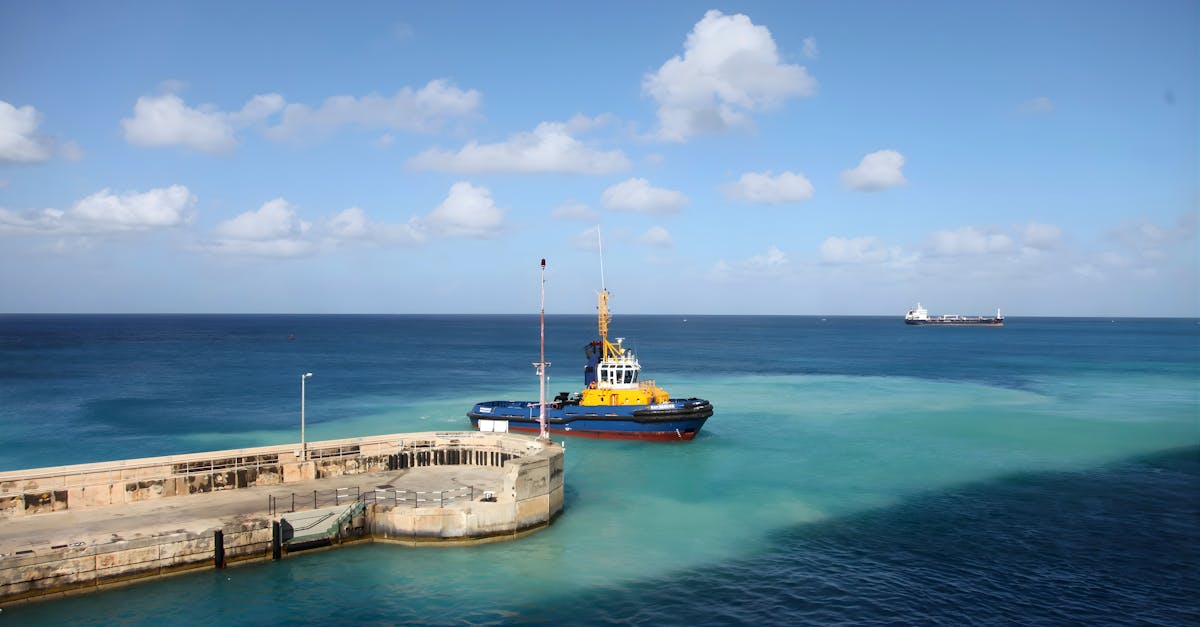 A vibrant tugboat by the dock in clear blue seas under a bright sky, ideal for travel themes.