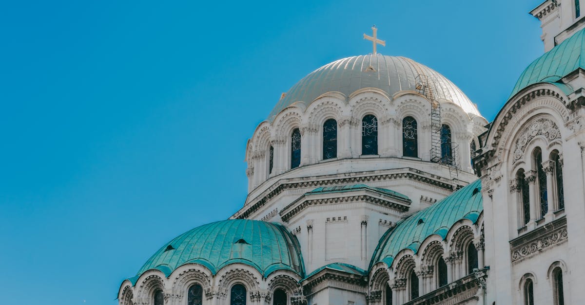 The iconic domes of Alexander Nevsky Cathedral against a clear blue sky in Sofia, Bulgaria.