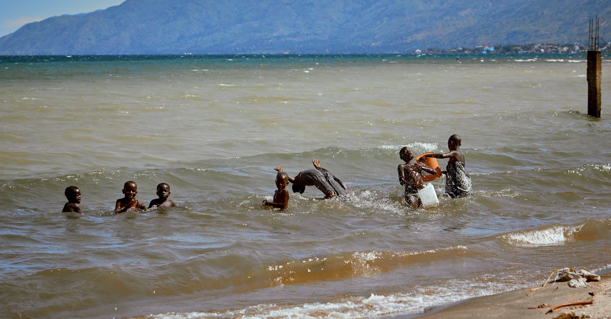 Joyful scene of children enjoying a sunny day in Lake Tanganyika, Africa.