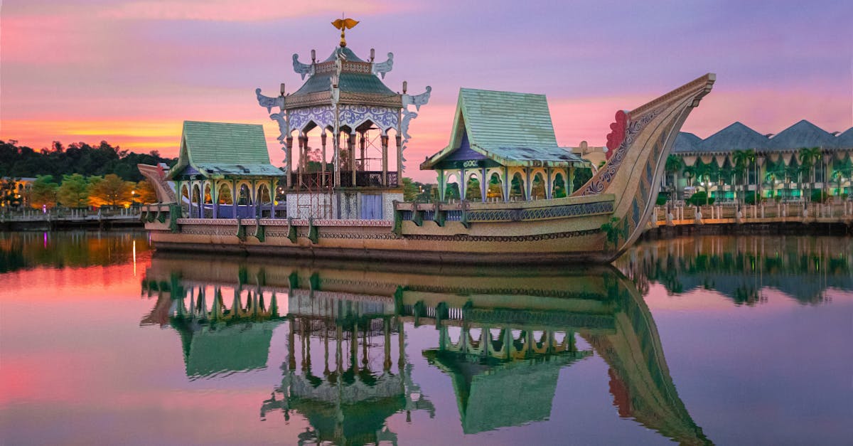 Stunning Brunei landmark reflecting in calm water during vibrant sunset.