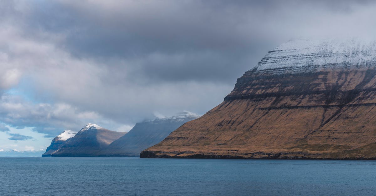 Breathtaking view of mossy cliffs and the Atlantic Ocean in the Faroe Islands.