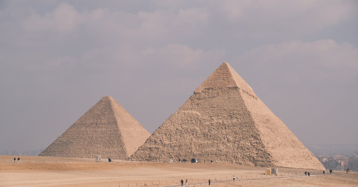Stunning photo of the Great Pyramids of Giza under a cloudy sky, showcasing Egypt's ancient architecture.