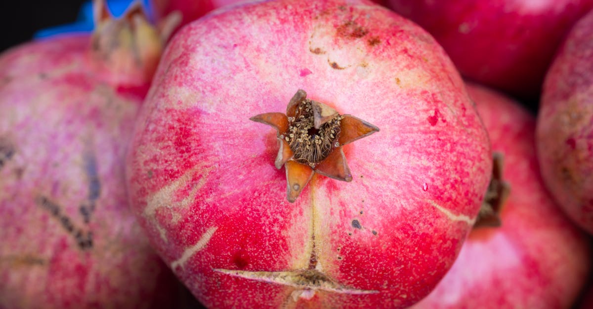 High-resolution close-up of ripe organic pomegranates showcasing texture and vibrant color.