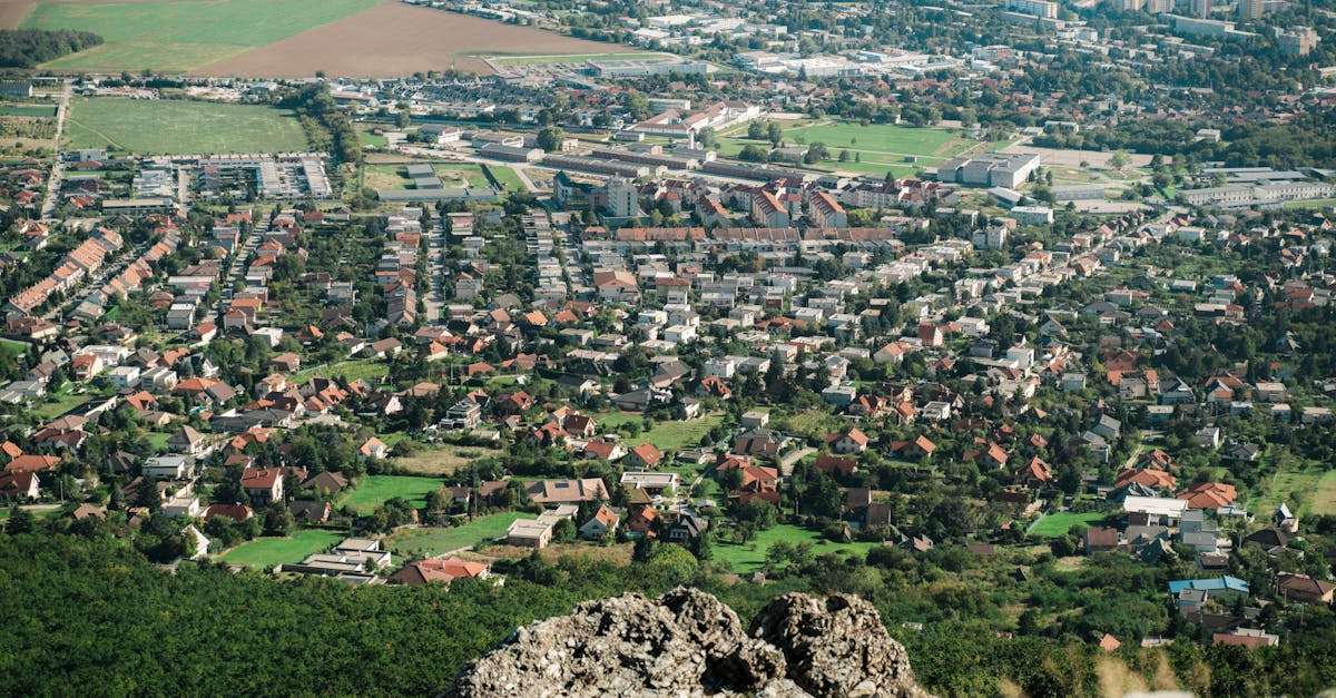 Breathtaking aerial view of Nitra cityscape surrounded by lush greenery and rolling hills.