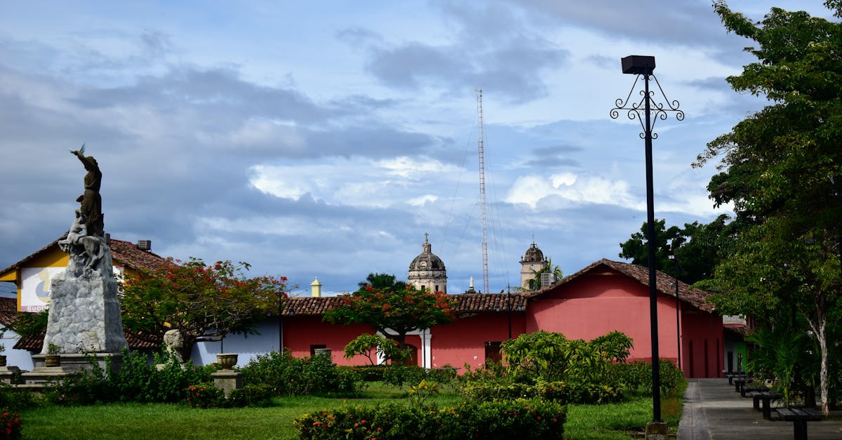 Colonial architecture and statue in a scenic town square on a cloudy day.