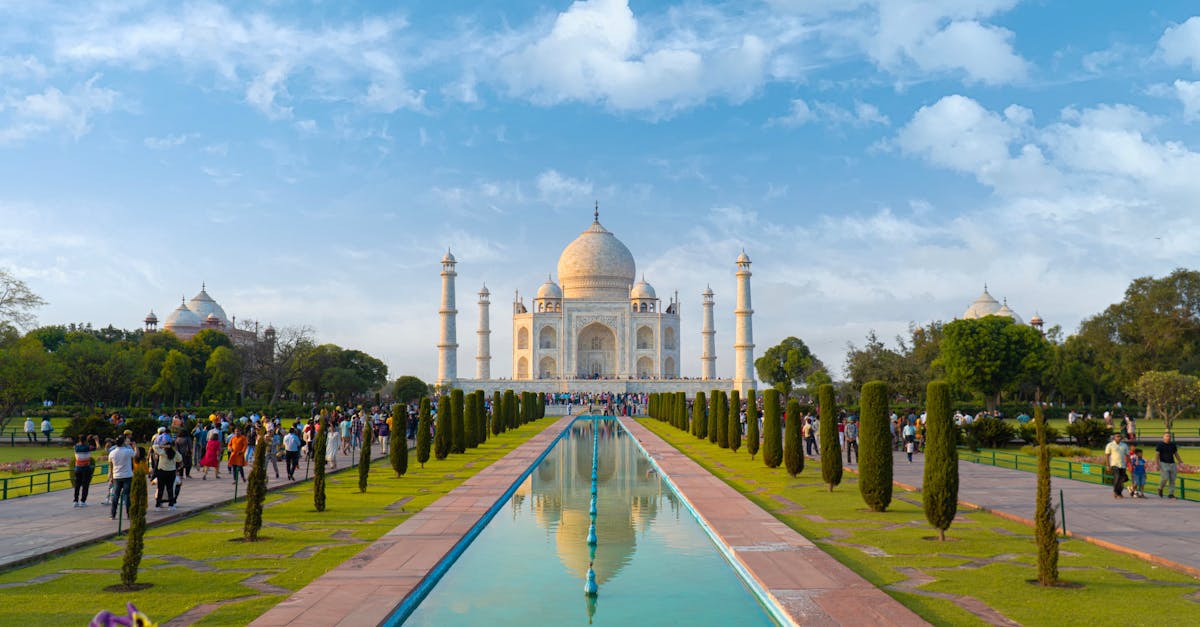A beautiful view of the Taj Mahal in Agra, India, with clear blue skies and vibrant gardens.