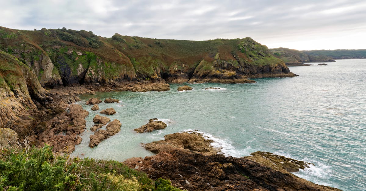 Breathtaking view of Jersey's rugged coastline with rocky cliffs and serene sea.