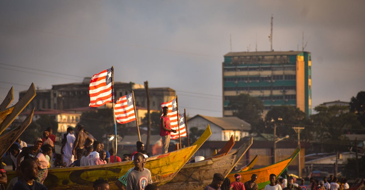 Vibrant scene of fishermen and canoes along the Monrovia coast during day.