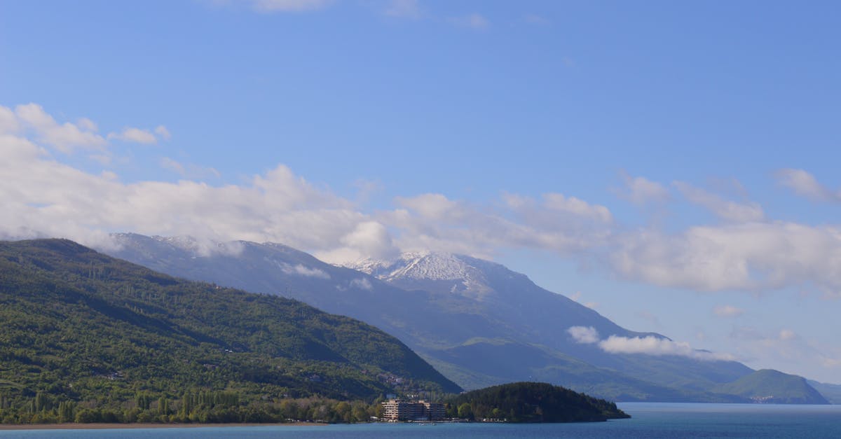 Serene landscape of Lake Ohrid with mountains under a clear blue sky in North Macedonia.