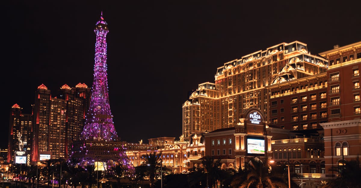 Vibrant night view of the Parisian Macao featuring its iconic illuminated Eiffel Tower replica.