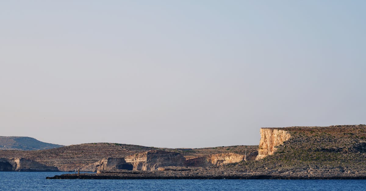 Breathtaking view of the rugged coastline of Malta under a clear blue sky.