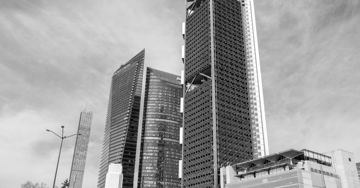 Black and white photo showcasing modern skyscrapers in Mexico City's skyline under a clear sky.