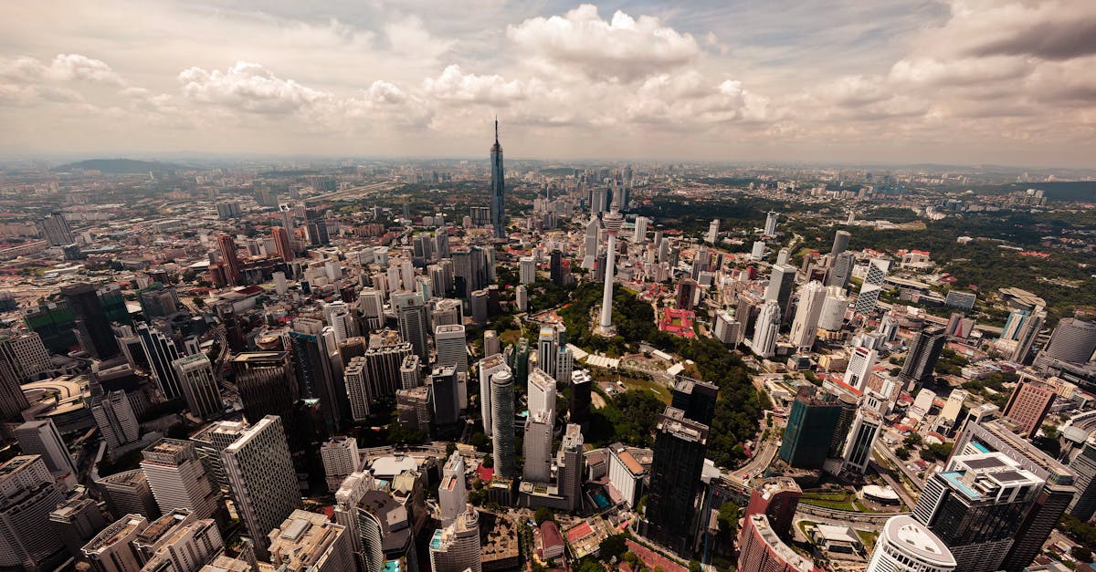 Stunning aerial view of Kuala Lumpur's cityscape featuring iconic skyscrapers and lush greenery.