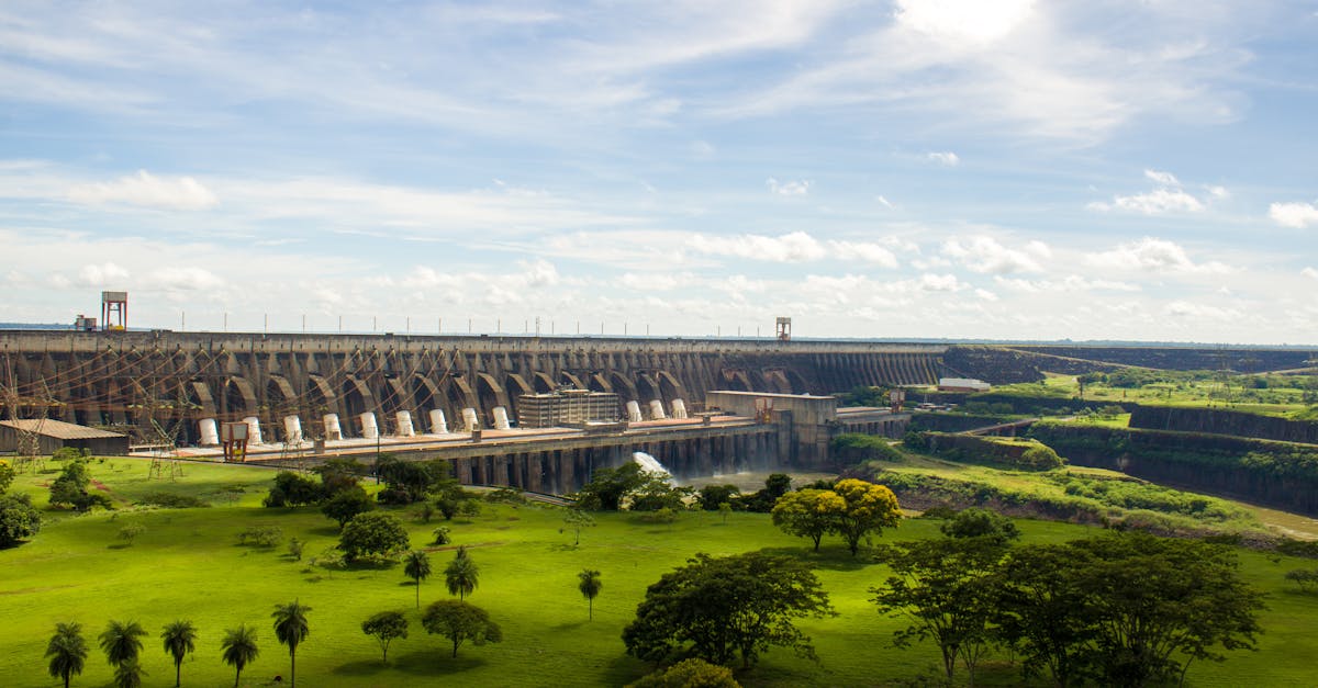 Experience the majestic Itaipu Dam surrounded by lush greenery in this scenic landscape view.