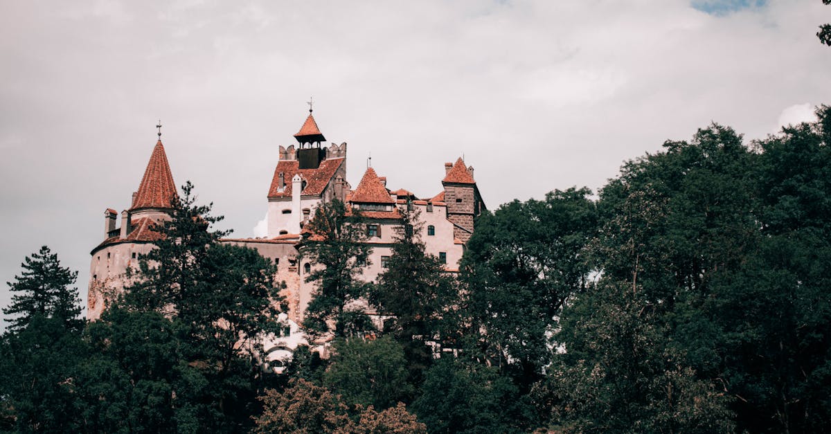 Explore the iconic Bran Castle nestled in the lush Transylvanian landscape, Romania.