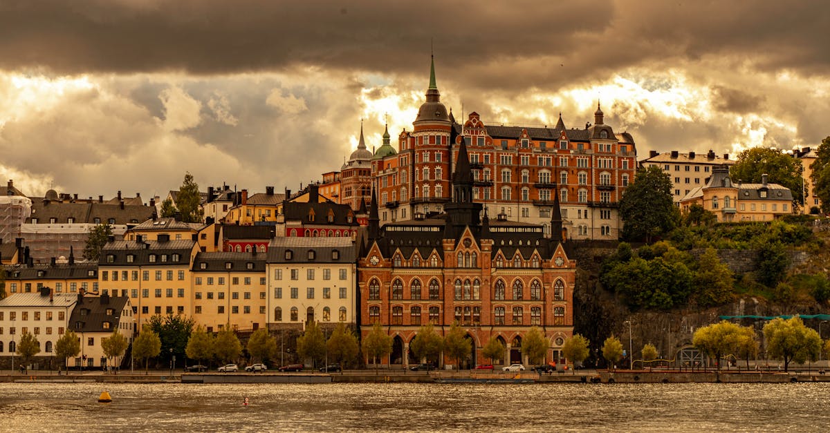 Dramatic view of historic buildings in Södermalm, Stockholm, under cloudy skies.