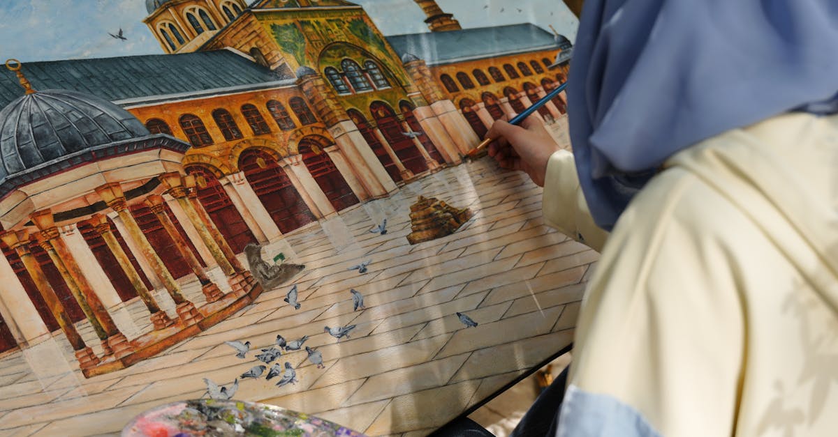 An artist paints the iconic Umayyad Mosque in Damascus while seated outdoors, capturing architectural details.