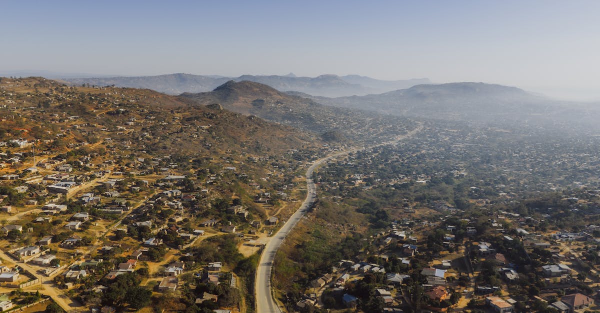 Aerial photograph capturing expansive rural landscape near eSwatini border, showcasing winding road through hills.