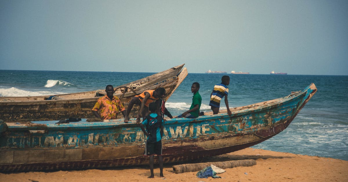 Captivating scene of fishermen and children with boats on a Togolese beach.