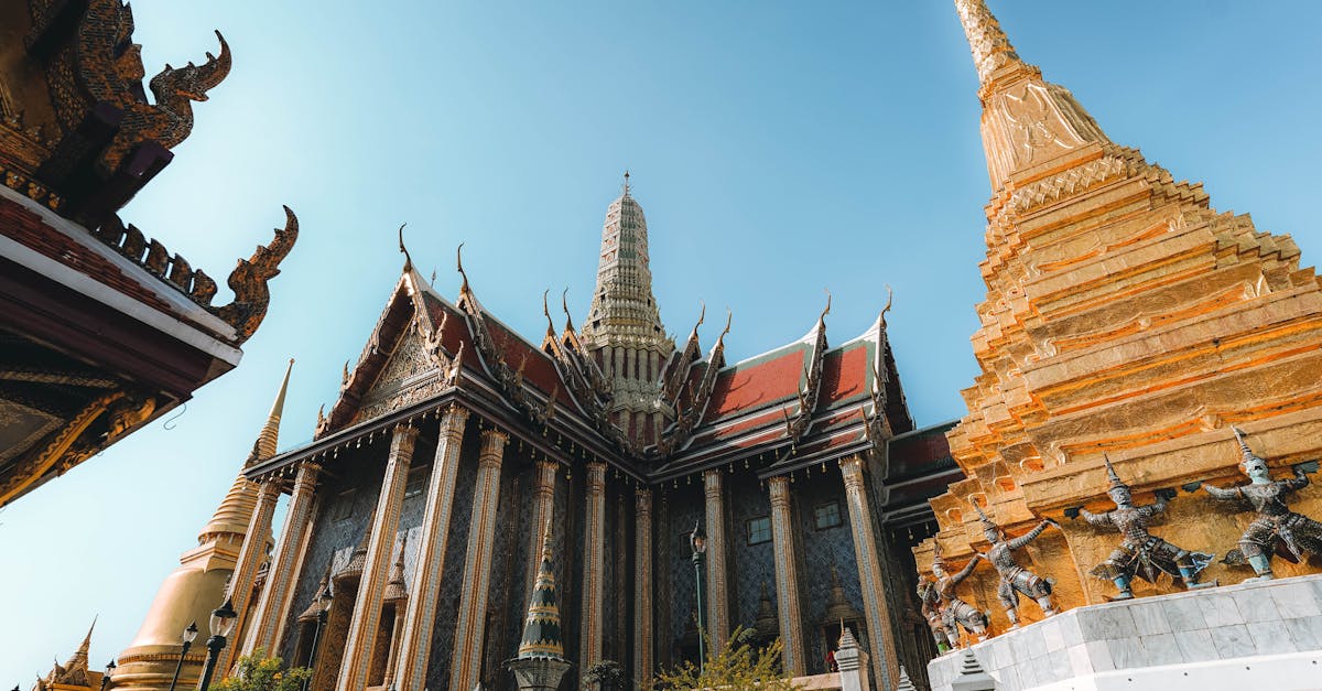 Beautiful capture of Grand Palace temple's intricate architecture and golden pagoda in Bangkok, Thailand.