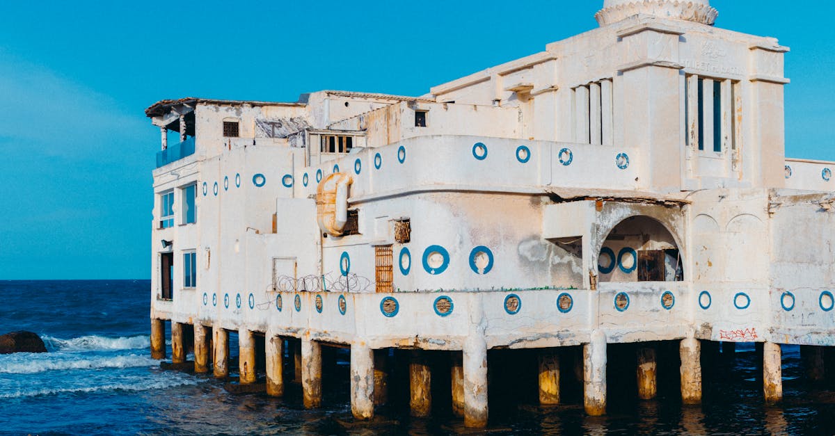 Striking image of a historic, abandoned building on the coast of La Marsa, Tunisia, surrounded by the blue sea.