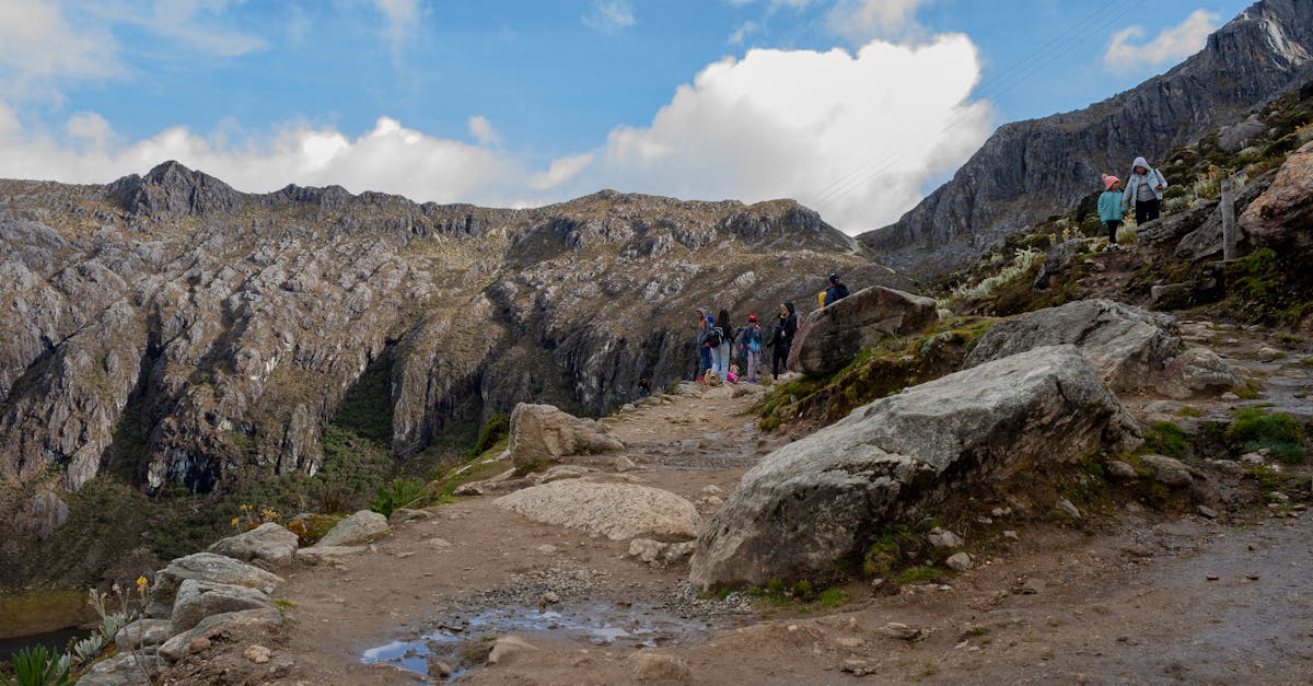 Explore the rugged beauty of Mérida's mountain range with hikers on a scenic trail.