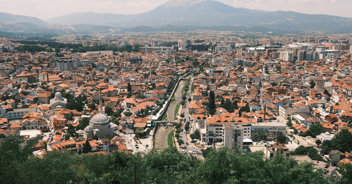 Explore the vibrant cityscape of Prizren with a stunning mountain backdrop.