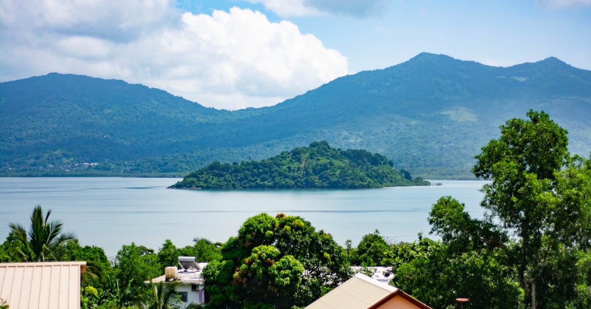 Beautiful landscape of an islet surrounded by the Indian Ocean in Mayotte, showcasing lush greenery and mountains.